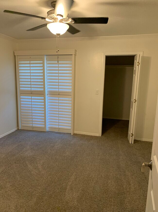 Bedroom with walk in closet and new double pane sliding glass doors to private balcony/deck - 436 N Bellflower Blvd