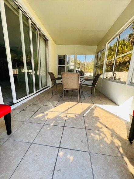 Enclosed screen in patio/Florida room - 71 Emerald Bay Dr