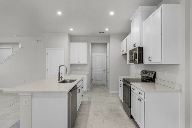 Building Photo - Brand-New 4BR Home with Tile Floors & Quar...