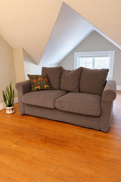 Bright upstairs landing with charming sloped ceilings and extra usable space. - 604 NE Shaver St