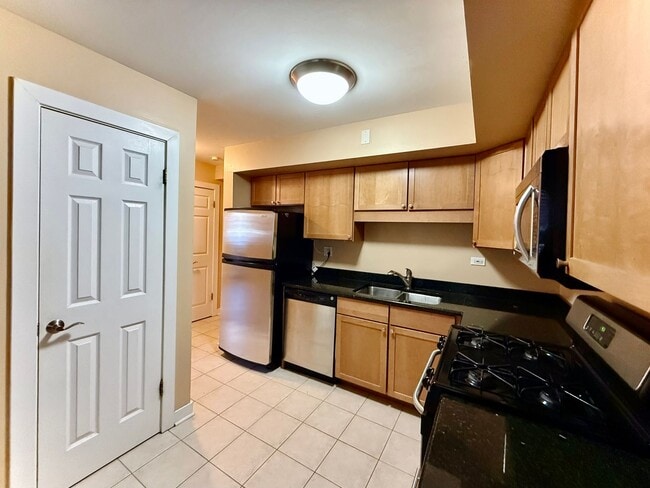 Building Photo - Pristine 2 Bedroom, 1 Bathroom Condo Available NOW! Heat, Water, & Parking INCLUDED in Rent!