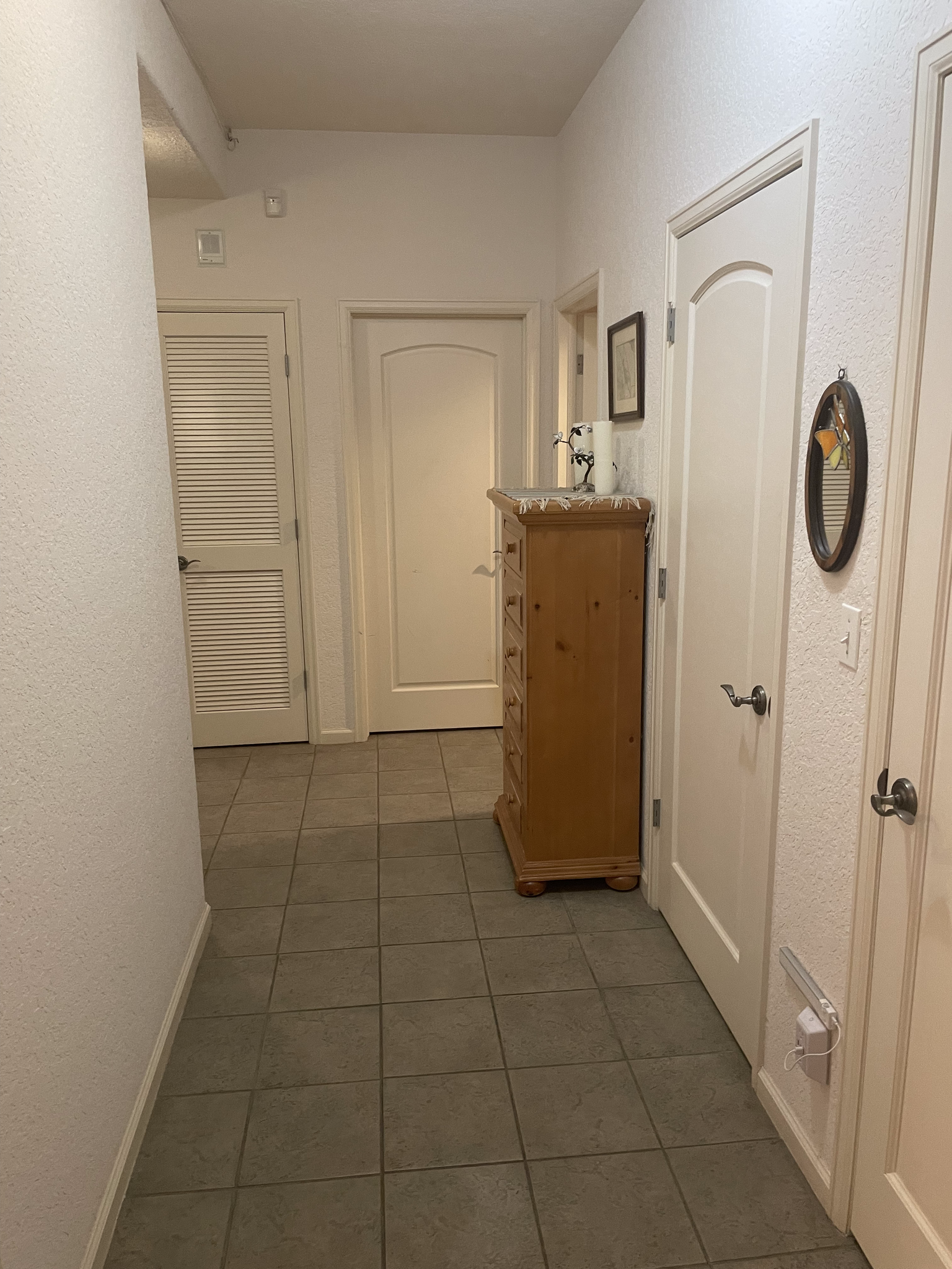 Hallway. BR2 directly in front; laundry to right, beyond the chest of drawers. - 13385 W 67th Pl