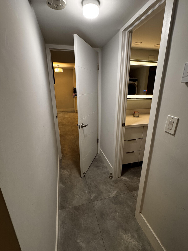 Hallway from the Master to the Living Room offers a privacy door. - 600 NE 36th St