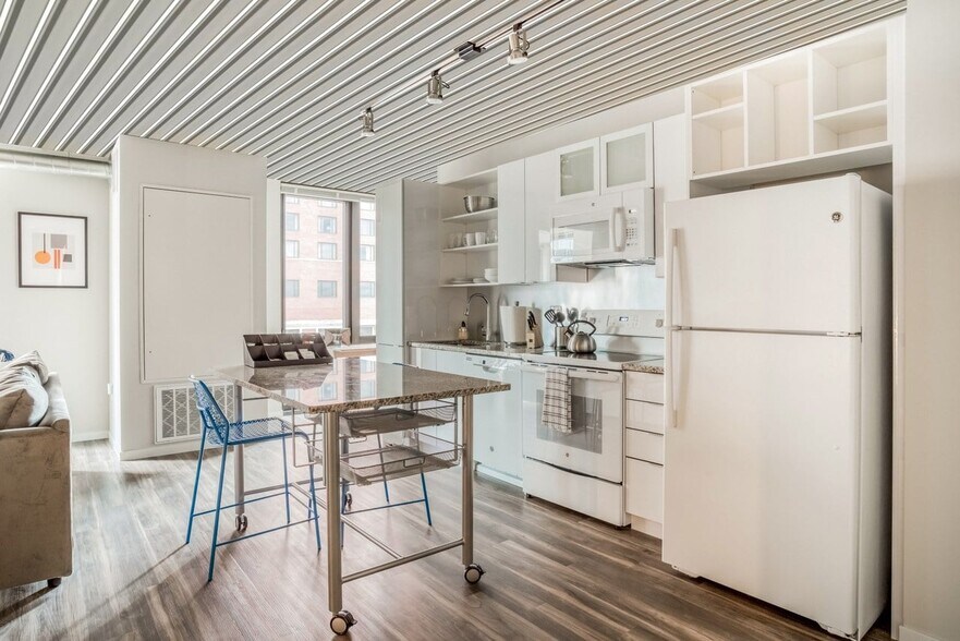 63 E Lake Apartments kitchen with white color scheme - 63 E Lake