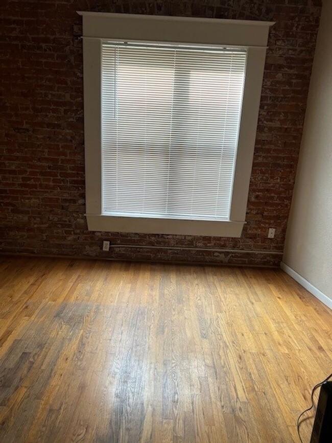 Building Photo - Large windows and exposed brick wall