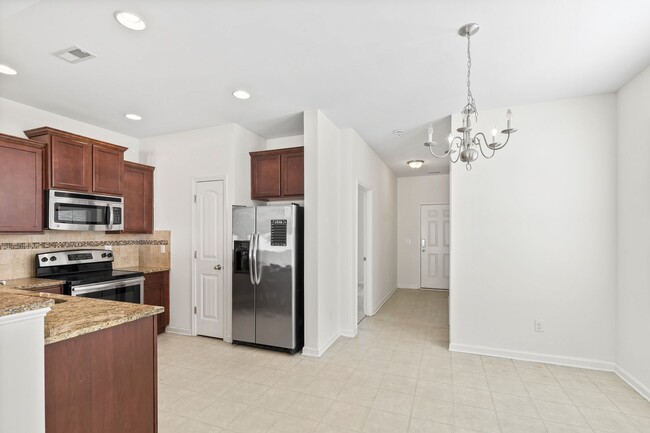 Building Photo - Spacious 4-Bedroom End-Unit Townhome in a ...