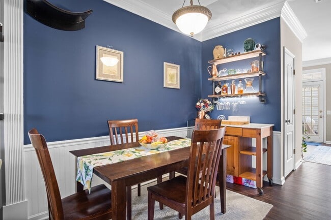 Building Photo - This inviting two-level townhome offers comfort and style, featuring gleaming hardwood floors on ...