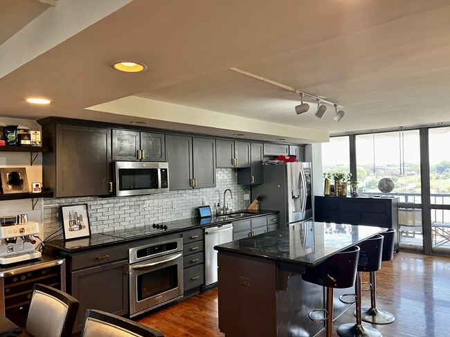 Kitchen with Granite Countertops, Glass Tile Backsplash, and Stainless Appliances - 600 Admiral Blvd