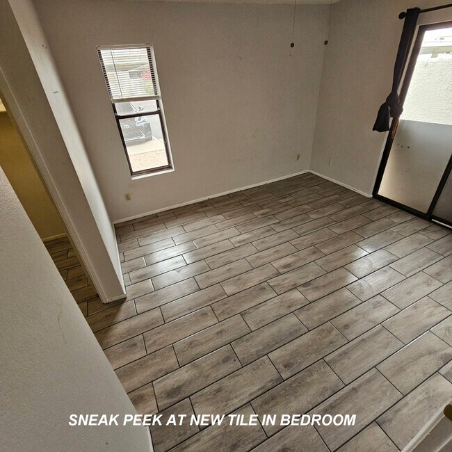 Sneak peek of beautiful new tile flooring in bedroom #2 - 850 S River Dr