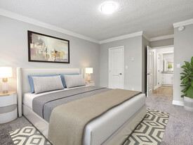 Well-lit carpeted bedroom with private bathroom. - Rose North