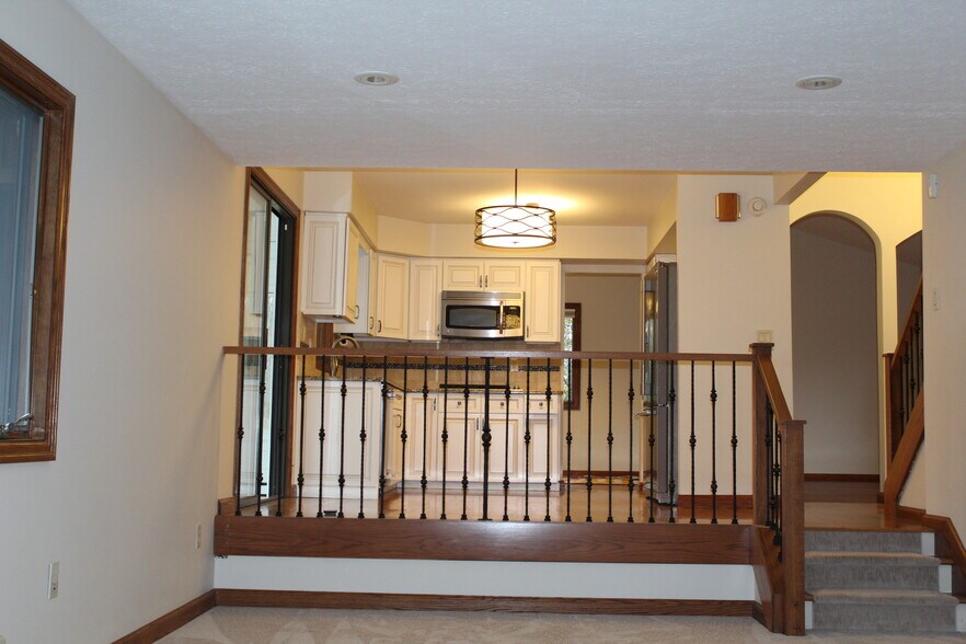 Open layout with the kitchen overlooking the adjacent living area for easy entertaining. - 6235 Sunnywood Dr