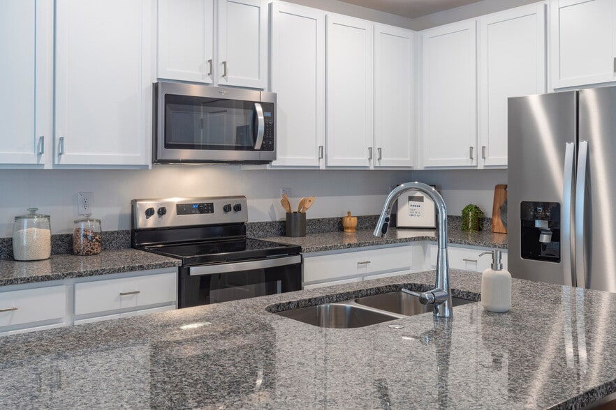 Kitchen with White Cabinets - The Preserve at Poinciana - Homes for Rent