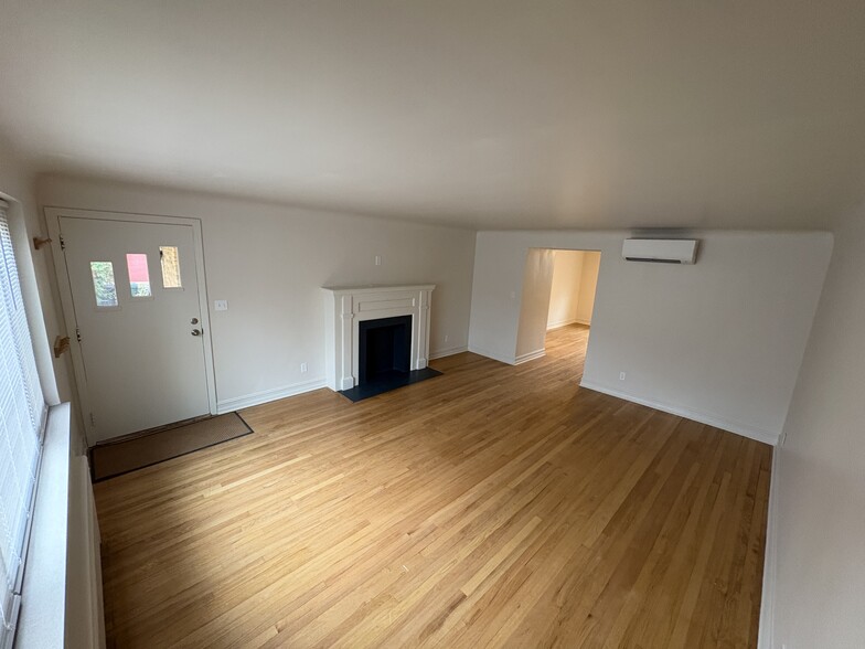 Spacious living room with decorative fireplace - 6035 Oakwood Ave