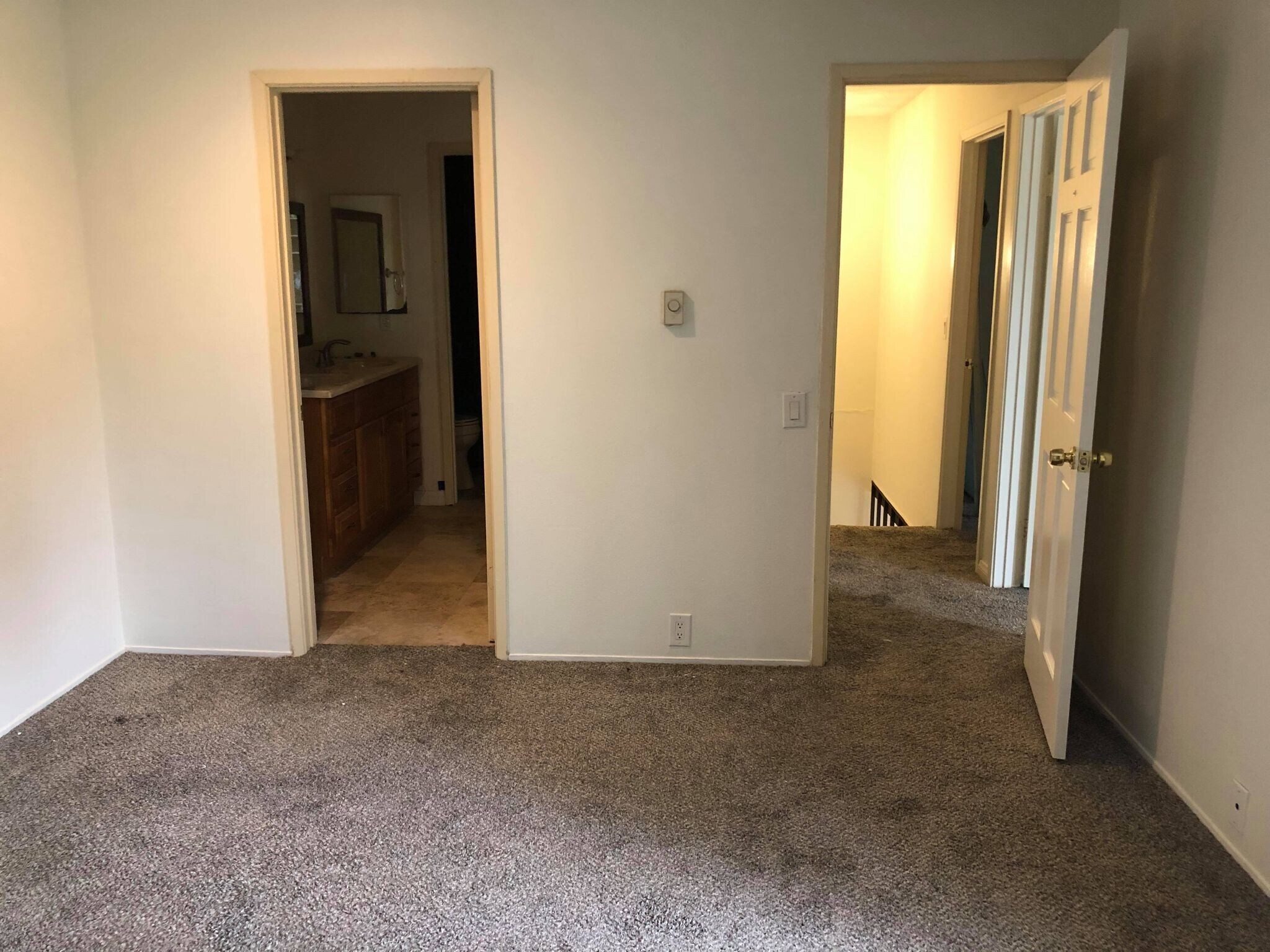Master bedroom; left door to shared area of full bathroom, right door to hallway - 9594 Easter Way
