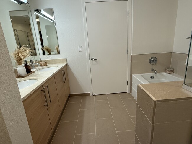 A spacious and elegant master bathroom featuring both a shower and a soaking tub. - 1655 N California Blvd