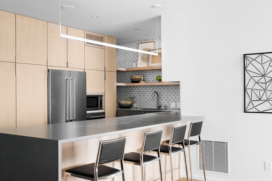 Kitchen complete with cabinet storage maximized with innovative Rev-a-Shelf pull-out organizers. - 1801 Lavaca St