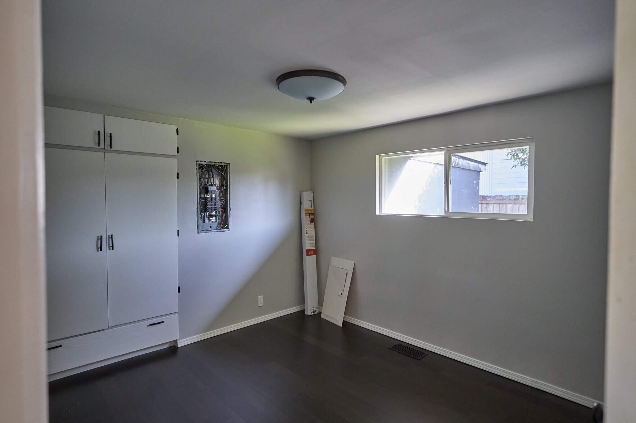 The electrical panel is now covered and the blinds are put up. - 904 S Junett