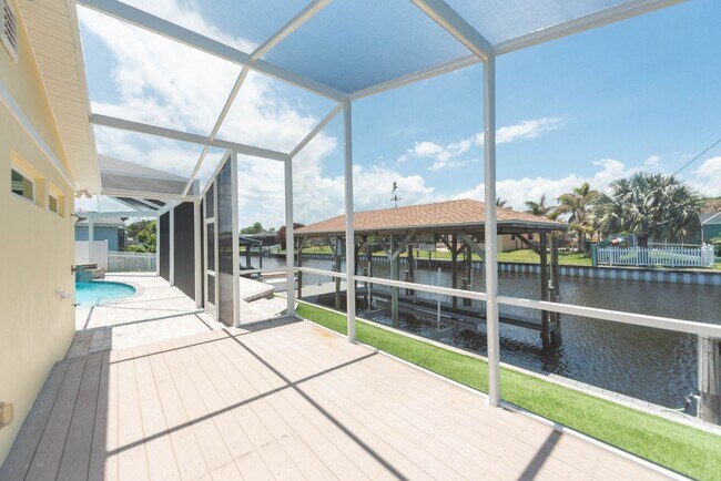 Building Photo - Live the ultimate Space Coast waterfront lifestyle at this stunning beachside canal home in Satel...