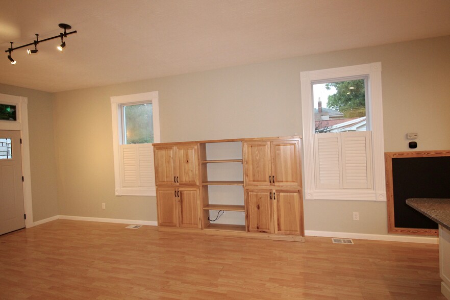 Built-in storage and shelving in airy great room. Plantation shutters provide easy privacy - 4536 Leo Street