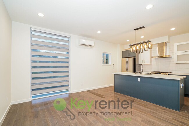 Building Photo - Rooftop Living with Open Concept Design and Parking Included