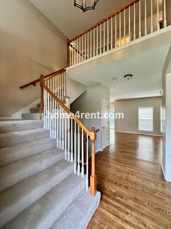 Building Photo - Beautiful Four-Bedroom Home with Three Car Garage, Wood Floors, Finished Basement and a Fenced Ya...
