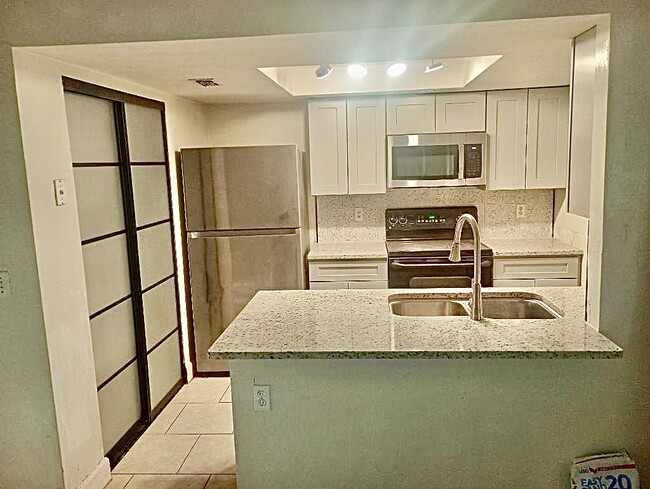 Newly remodeled kitchen with granite countertops and frosted glass pantry - 2858 Wonderwood Ln