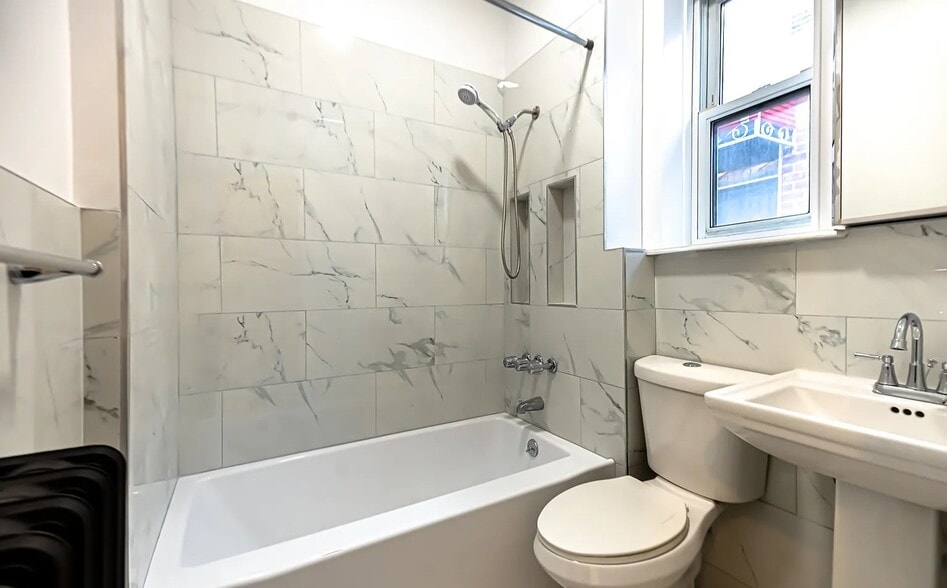 Newly renovated bathroom with modern fixtures and fresh finishes - 586 Remsen Ave