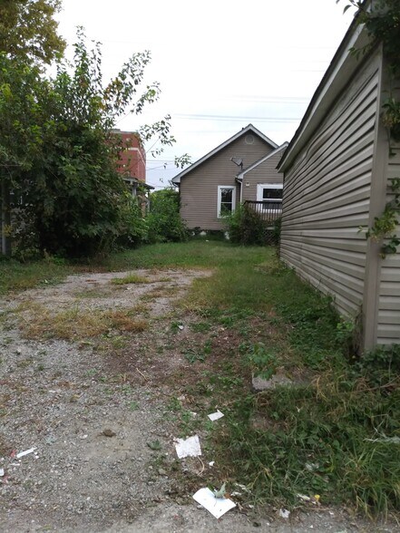 Parking pad next to garage with view of back of house - 2305 7th Street Rd