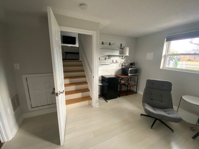View of the kitchenette and stairs to the main living floor. - 7922 Fitzroy St