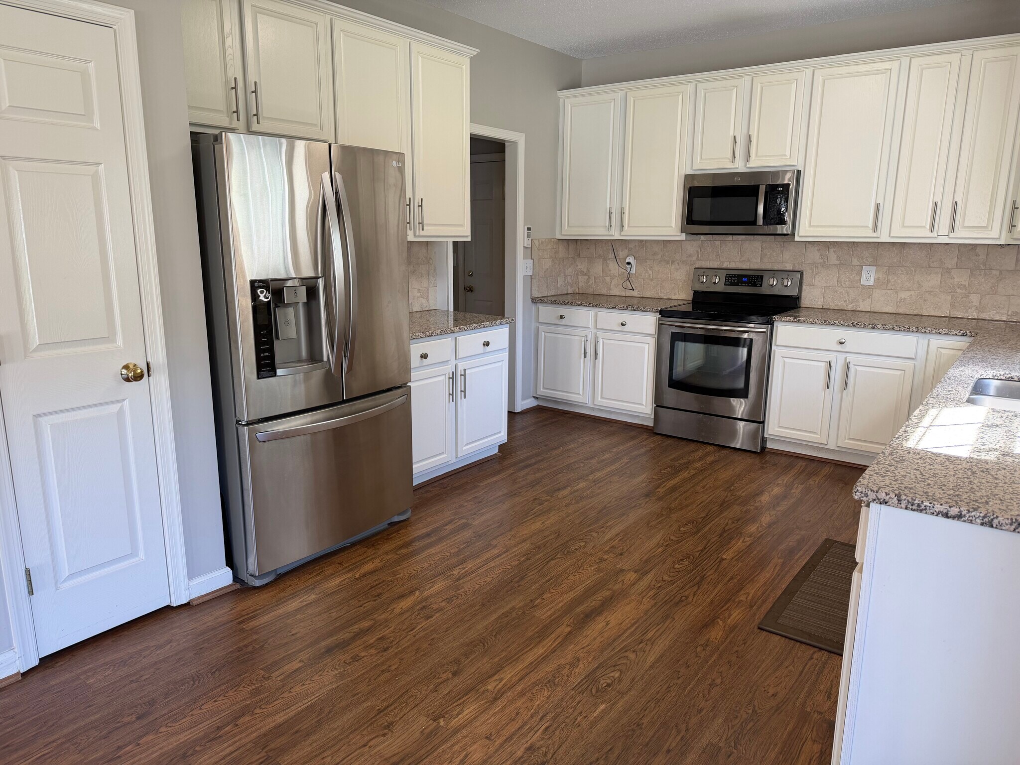 Updated kitchen features granite counter tops, tile backsplash, and Stainless Steel appliances - 6419 Woodmont Rd