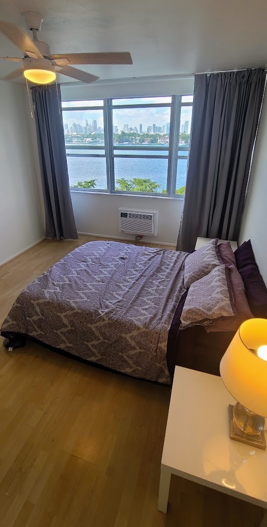 Bedroom staged with queen-size bed. - 3 Island Ave