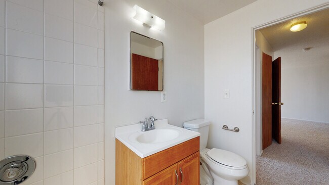 Experience functionality in a bright and modern bathroom setting. - Harmony Apartments