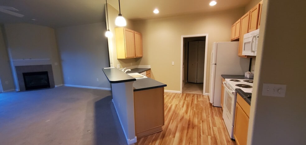 Open floor plan. Kitchen breakfast bar, LR. - 2214 Owens Ave