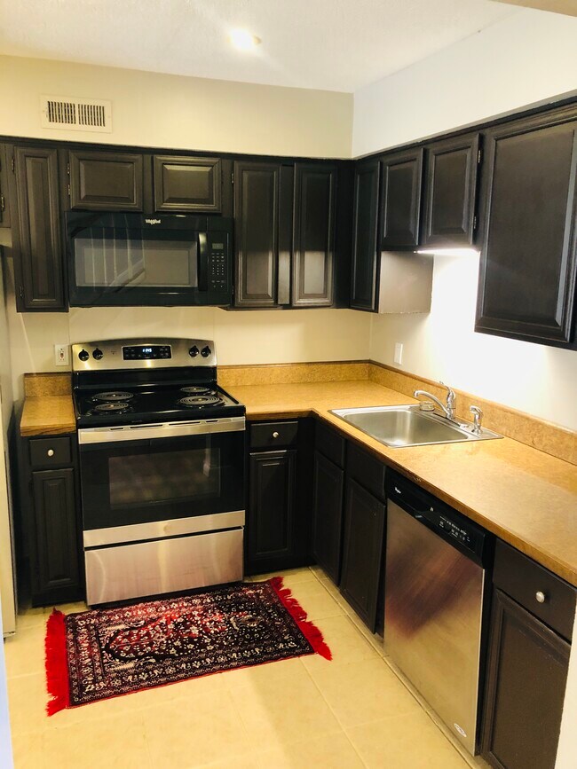 Kitchen with stainless steel appliances - 2550 W Village Dr