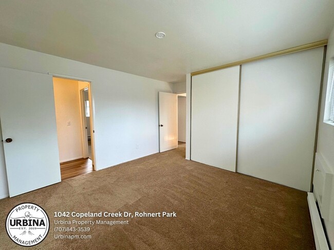 Building Photo - Charming 2-Bed, 1.5-Bath End-Unit Condo in...