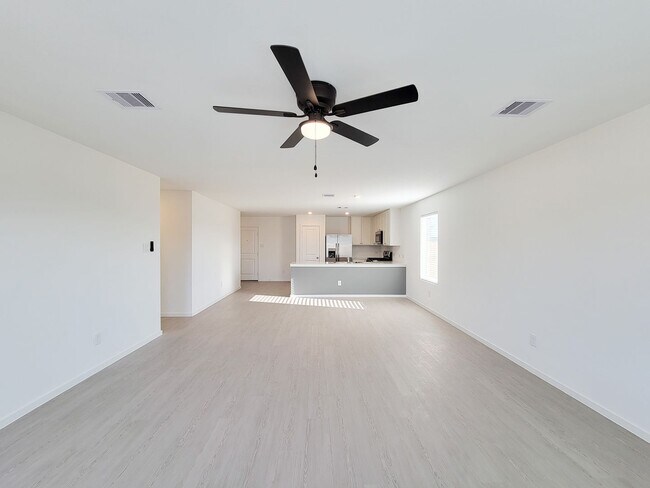 Building Photo - This single-level home showcases a spacious open floorplan shared between the kitchen, dining are...