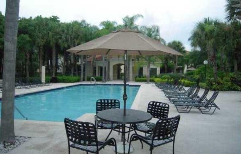 here are tables and lounge chairs around both pools. - 550 S Park Rd