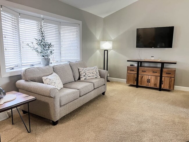 The upstairs living space with a full-sized sofa and a lounge chair. - 1237 Giesse Dr