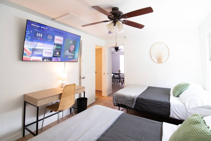 Bedroom with study area and 65" Roku TV - 5901 W Cypress St