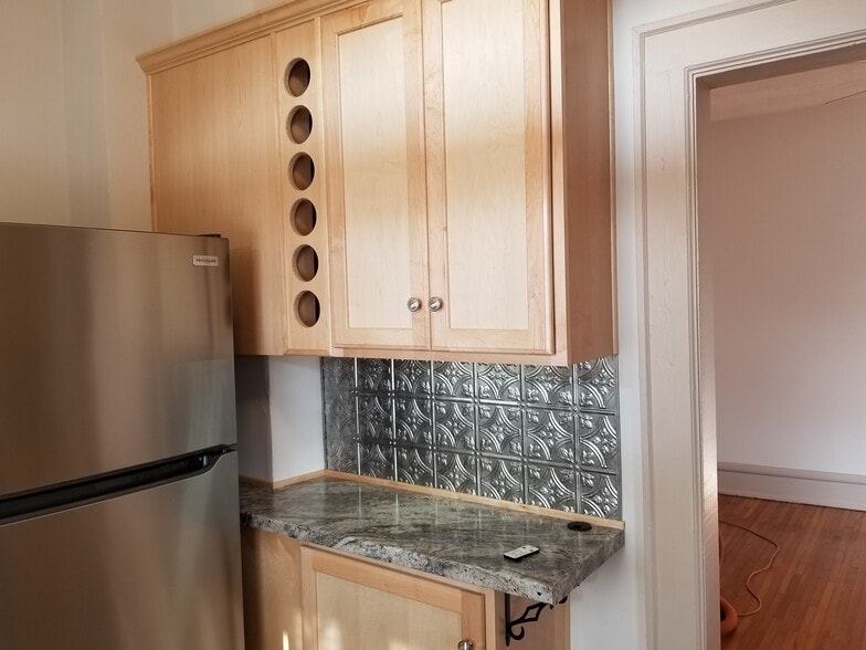 Kitchen with Wine Holder Maple Cabinetry - 143 W 1st Ave