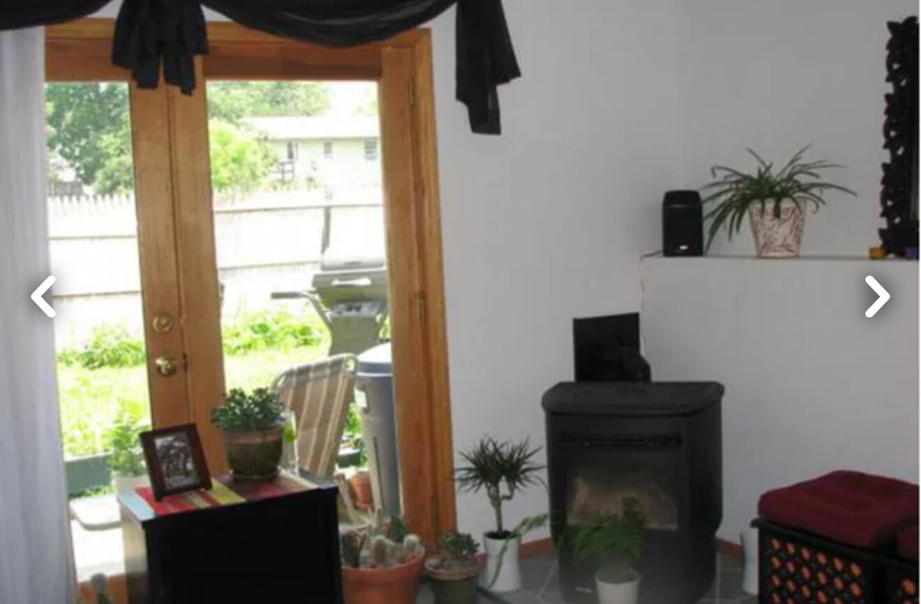 Living room view showing French patio doors and Wood burning pellet stove fire place - 26 Rochester St