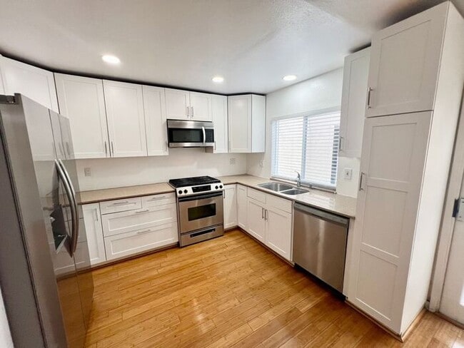 Building Photo - Stunning 4BR Townhome with Hardwood Floors, Private Patio, Community Pool & 2-Car Garage!