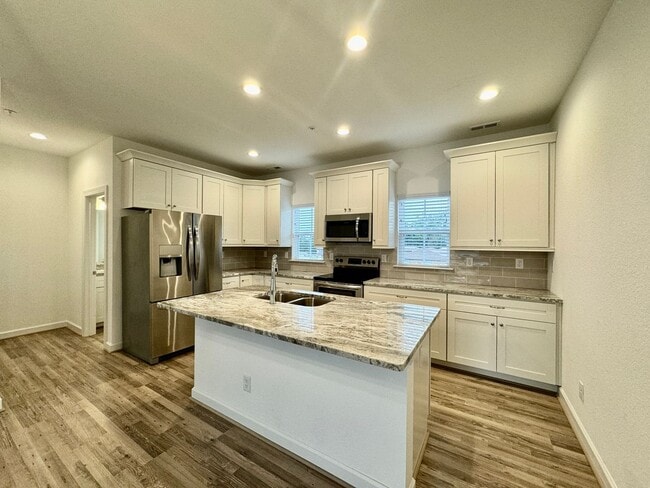 Building Photo - Practically New & Available NOW! Americana Luxury Townhomes! Pet Friendly! Attached Garage! All A...