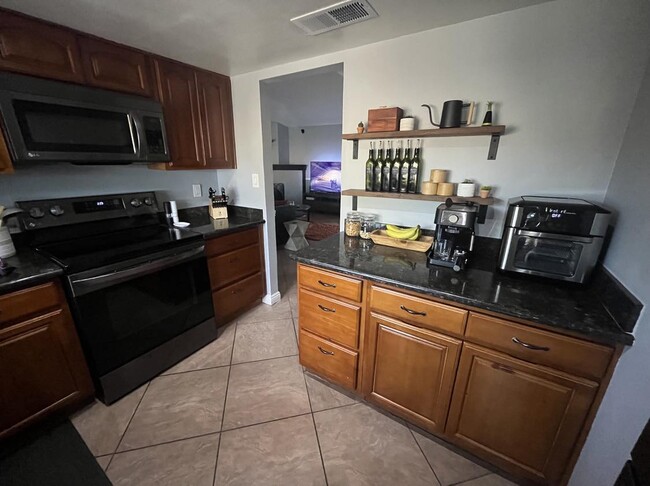 Kitchen with stainless steel appliances - 9440 N 52nd Ln