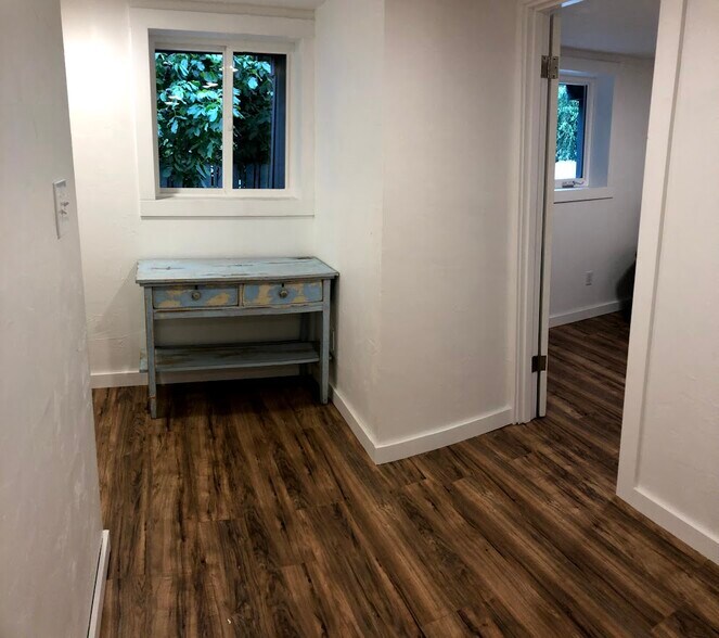 End of hallway with bedroom door on right. We converted the end of hallway into a second office space. - 2415 E 12th St