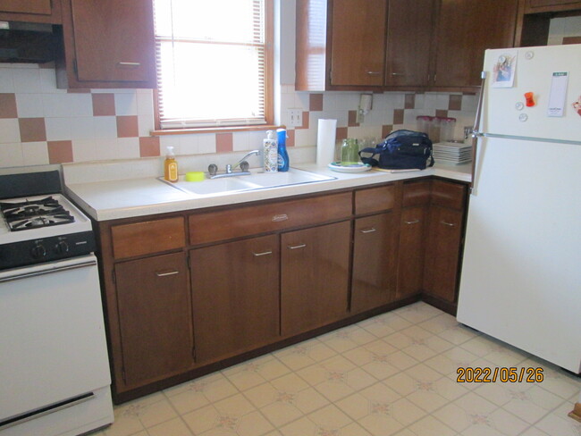 Kitchen with stove and refrigerator - 3936 Liberty St