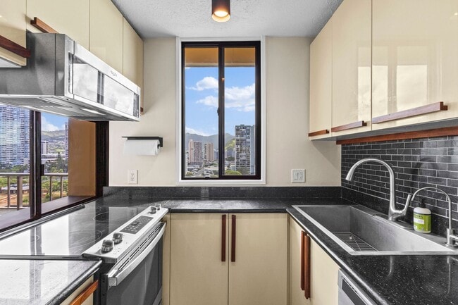 Building Photo - Wake Up to Stunning Mountain & Ala Wai Canal Views in the Heart of Waikiki