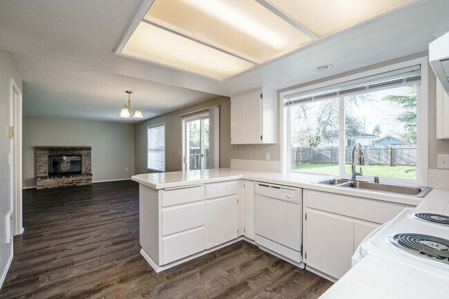 Building Photo - Recently Updated with Wood Laminate Flooring and Fresh Paint