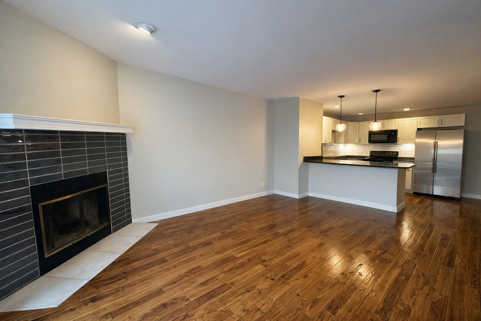Open living space with a classic wood-burning fireplace. - 524 Superior St