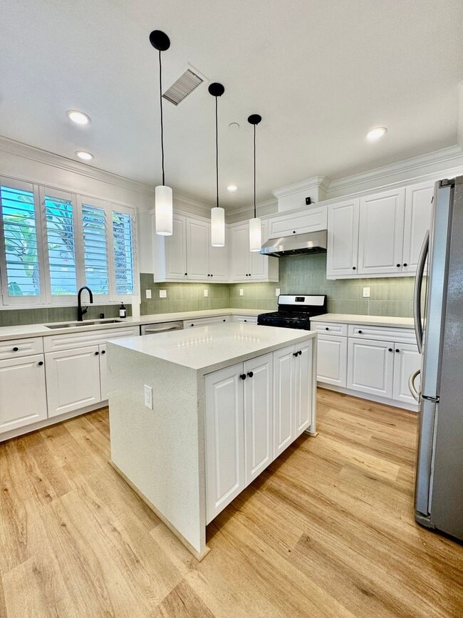 Building Photo - Beautifully Remodel Townhouse with AC & Two Car Garage!